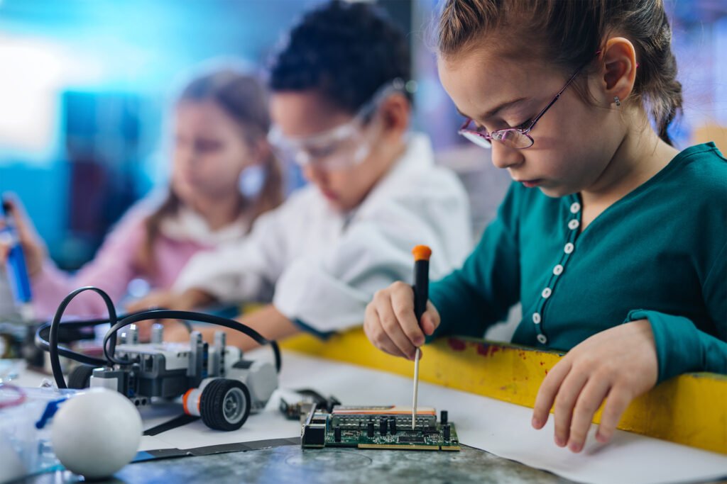 Small girl working on motherboard in laboratory.